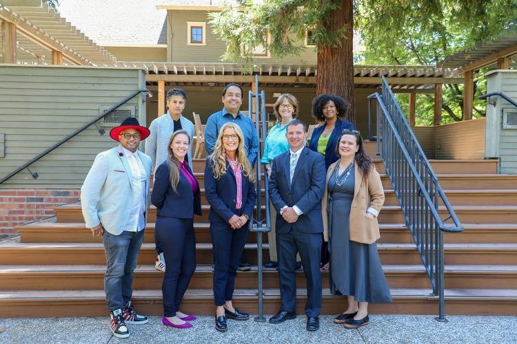 A group of McGeorge faculty pose for a photo outside.